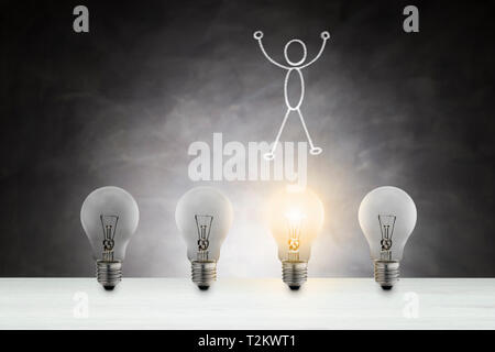 Concept of idea. Light bulb lit among unlit bulbs.