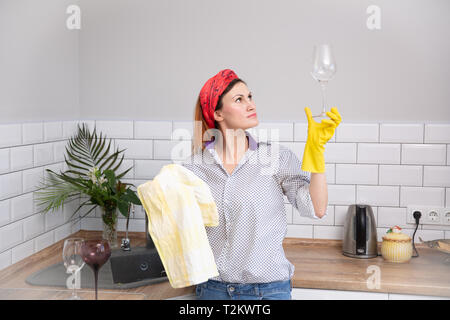 Woman cleaning or ruges glass in the kitchen. housekeeper doing spring cleaning Stock Photo