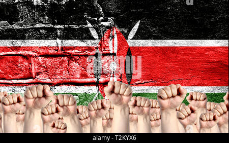 Male hands clenched in a fist raised up against the backdrop of a destroyed brick wall with a flag of Kenya. The concept of the labor movement from th Stock Photo