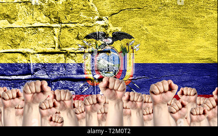 Male hands clenched in a fist raised up against the backdrop of a destroyed brick wall with a flag of Ecuador. The concept of the labor movement from  Stock Photo