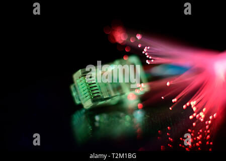 Network cable with fiber optics light on black background Stock Photo