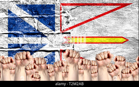 Male hands clenched in a fist raised up against the backdrop of a destroyed brick wall with a flag of Newfoundland and Labrador. The concept of the la Stock Photo