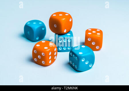 A group of blue and red colored playing dice for board games on a white uniform background Stock Photo