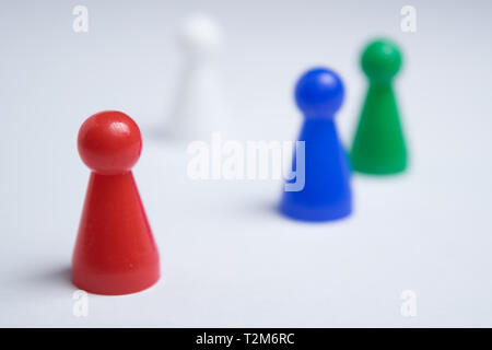 A group of colorful game board pawns isolated on a white uniform background Stock Photo