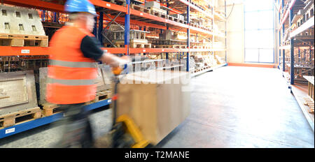 logistics and transport workers in a goods warehouse with goods for storage and shipping Stock Photo