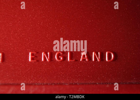 Made in England inscription printed on red plastic surface, close-up Stock Photo