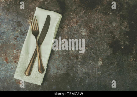 Vintage cutlery and napkin on Grunge background Stock Photo