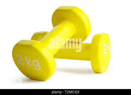 Two yellow  dumbbells isolated on white background with clipping path Stock Photo