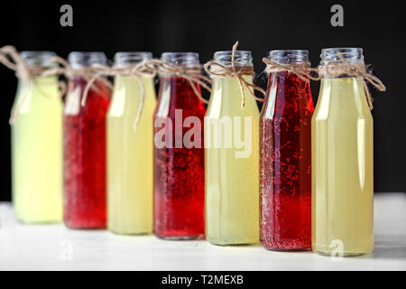 Refreshing citrus and pomegranate lemonade in glass bottles. Concept of drinks, summer, bar, rest, healthy food Stock Photo