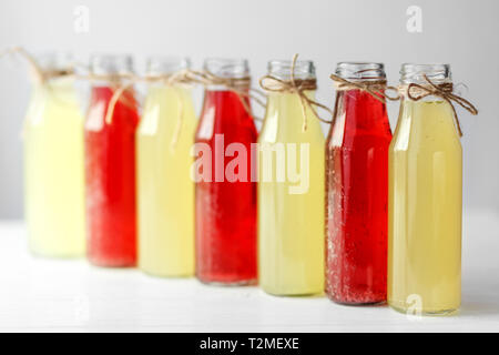 Delicious citrus and pomegranate lemonade in glass bottles. Concept of drinks, summer, bar, rest, healthy food Stock Photo
