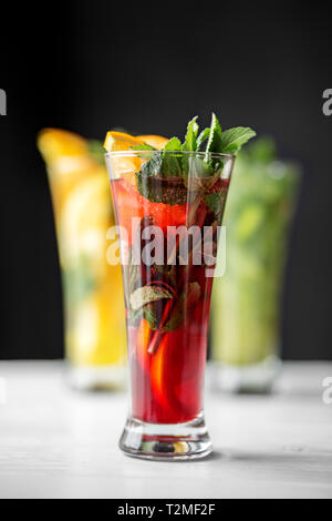 Alcoholic red cocktail with mint in a glass goblet. The range of drinks. Concept for drinks, summer, heat, alcohol, party and bar. Stock Photo