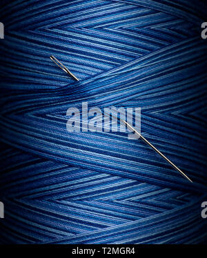 Close up of Needle in Blue Thread Stock Photo