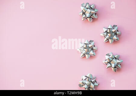 Fashion gifts or presents boxes with golden bows and star confetti on pink pastel table top view. Flat lay composition for birthday, christmas or wedd Stock Photo