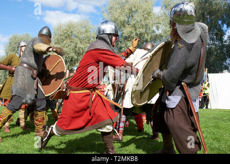 Hämeenlinna, Finland -  August 17, 2014: Vikings fighting with swords and shields at the medieval festival on a sunny summer day. Stock Photo