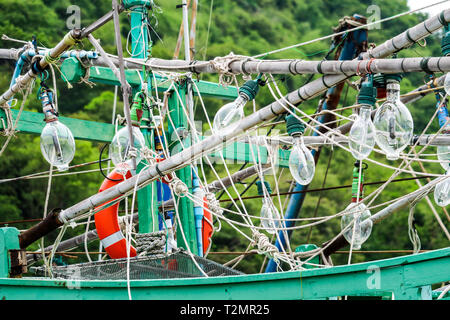 Spotlights was hanging on a fishing boat and squid fishing to catch the fish in the night Stock Photo
