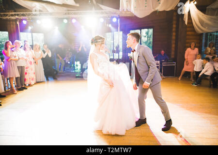 First wedding dance of newlywed couple in restaurant. Stock Photo