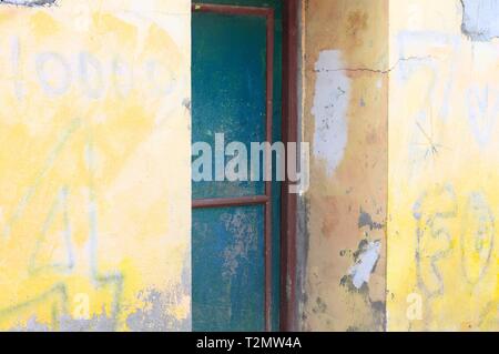 Blue steel door and a yellow wall background (Ari Atoll, Maldives) Stock Photo