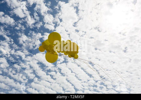 multicolored balloons and confetti in the city festival. Stock Photo