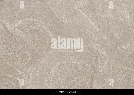 A top down shot of a dry river beige sand bottom full of texture and salt marks. Useful as abstract background. Stock Photo