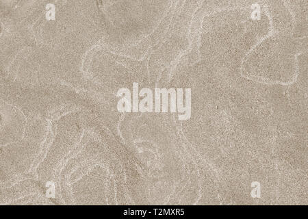 A top down shot of a dry river beige sand bottom full of texture and salt marks. Useful as abstract background. Stock Photo