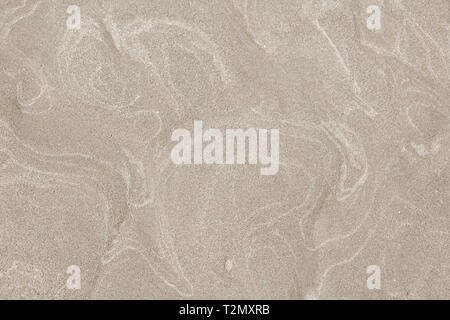 A top down shot of a dry river beige sand bottom full of texture and salt marks. Useful as abstract background. Stock Photo
