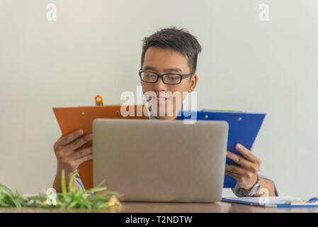 Businessman reading financial documents in the office Stock Photo