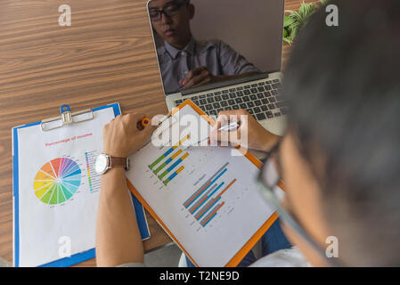 Office employee checking financial number on sale report Stock Photo