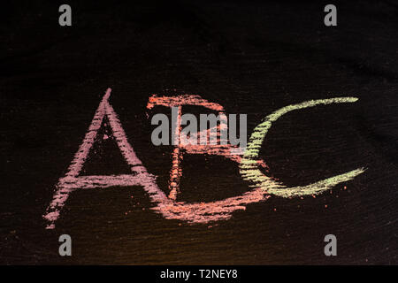 colorful ABC letters chalk font on blackboard, scholl concept Stock Photo