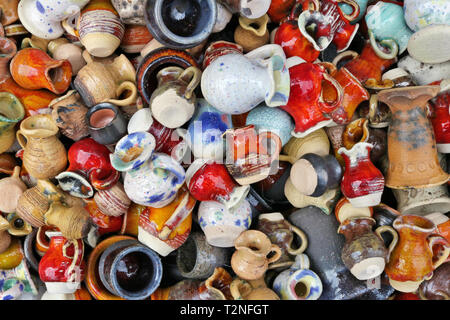 Small ceramic  jugs and cups lie on a street in spring fair time.  Outdoor  background Stock Photo