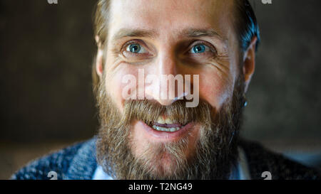 Close Up Portrait of A Man with a Beard is Talking and Laughing. Joyful Communication Concept Stock Photo