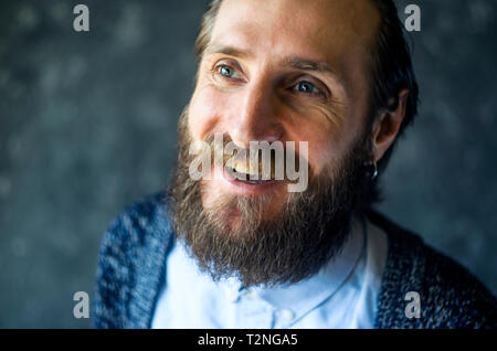 Close Up Portrait of a Happy Smiling Man with a Beard is Talking and Laughing. Joyful Communication Concept Stock Photo