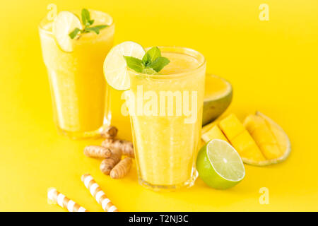Mango and turmeric smoothie and ingredients, copy space Stock Photo