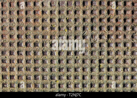 Many handmade square holes  in the iron rusty vintage  sheet. Vintage  metal background Stock Photo