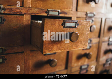 Old vintage file catalog box with many wooden index drawers in library ...