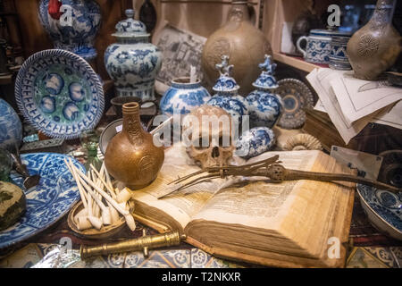 Various items are artfully placed for sale at an antique shop in Amsterdam, Netherlands Stock Photo