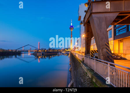 Harbor in Düsseldorf Germany with famous Rheinturm Tower at Dusk Stock Photo