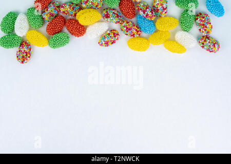 Top view of colored candy on a white background with space next to it Stock Photo