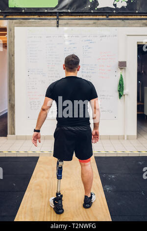 Man with prosthetic leg walking away Stock Photo