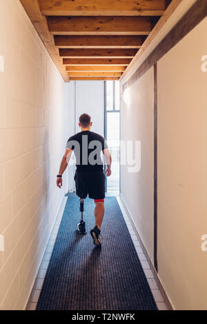 Man with prosthetic leg walking away Stock Photo