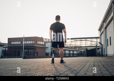 Man with prosthetic leg walking Stock Photo