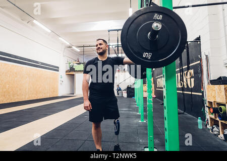 Man with prosthetic leg training in gym Stock Photo