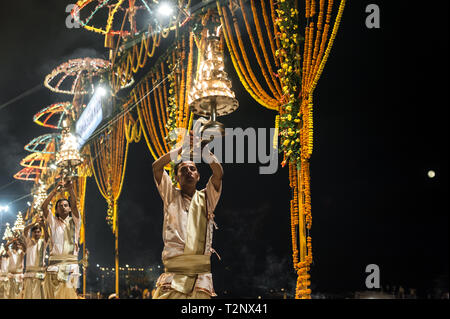 Hindu priests perform rituals during the evening Ganga Seva Nidhi, a religious Hindu ceremony that takes place twice every day. Stock Photo
