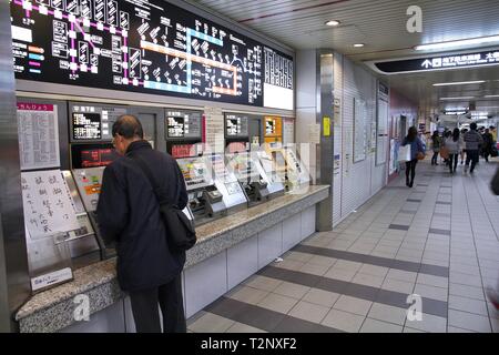 KYOTO, JAPAN - APRIL 14, 2012: Traveler buys tickets for Kyoto Municipal Subway train in Kyoto, Japan. Kyoto Subway exists since 1981, has 29 stations Stock Photo