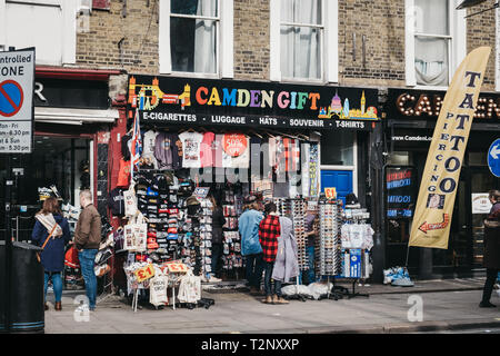 London, UK - March 23, 2019: People walking past the a souvenir shop on a street in Camden Town, London, an area famed for its market and nightlife an Stock Photo