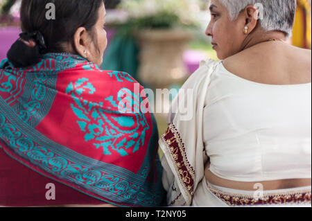 Two middle aged Indian women talk privately. Stock Photo