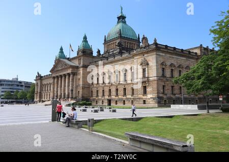 LEIPZIG, GERMANY - MAY 9, 2018: People walk by Federal Administrative Court (Bundesverwaltungsgericht) in Leipzig, Germany. It is one of five supreme  Stock Photo