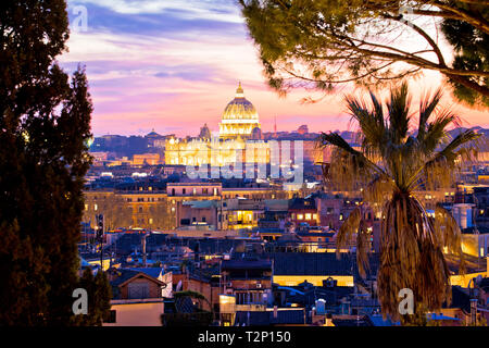 Rome rooftops and dome of the Papal Basilica of Saint Peter in Vatican evening view, capital city of Italy Stock Photo