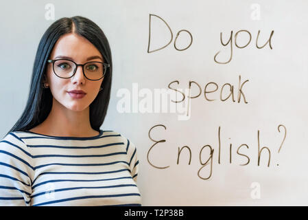 Portrait of attractive student or teacher of English language and words do you speak English Stock Photo