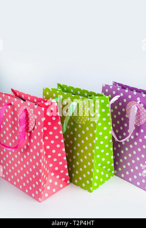 Three multi-colored shopping bags close-up. Stock Photo