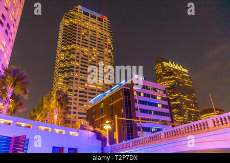 Downtown Tampa Florida buildings lit up at night with colorful lights as seen from the Tampa Riverwalk Stock Photo